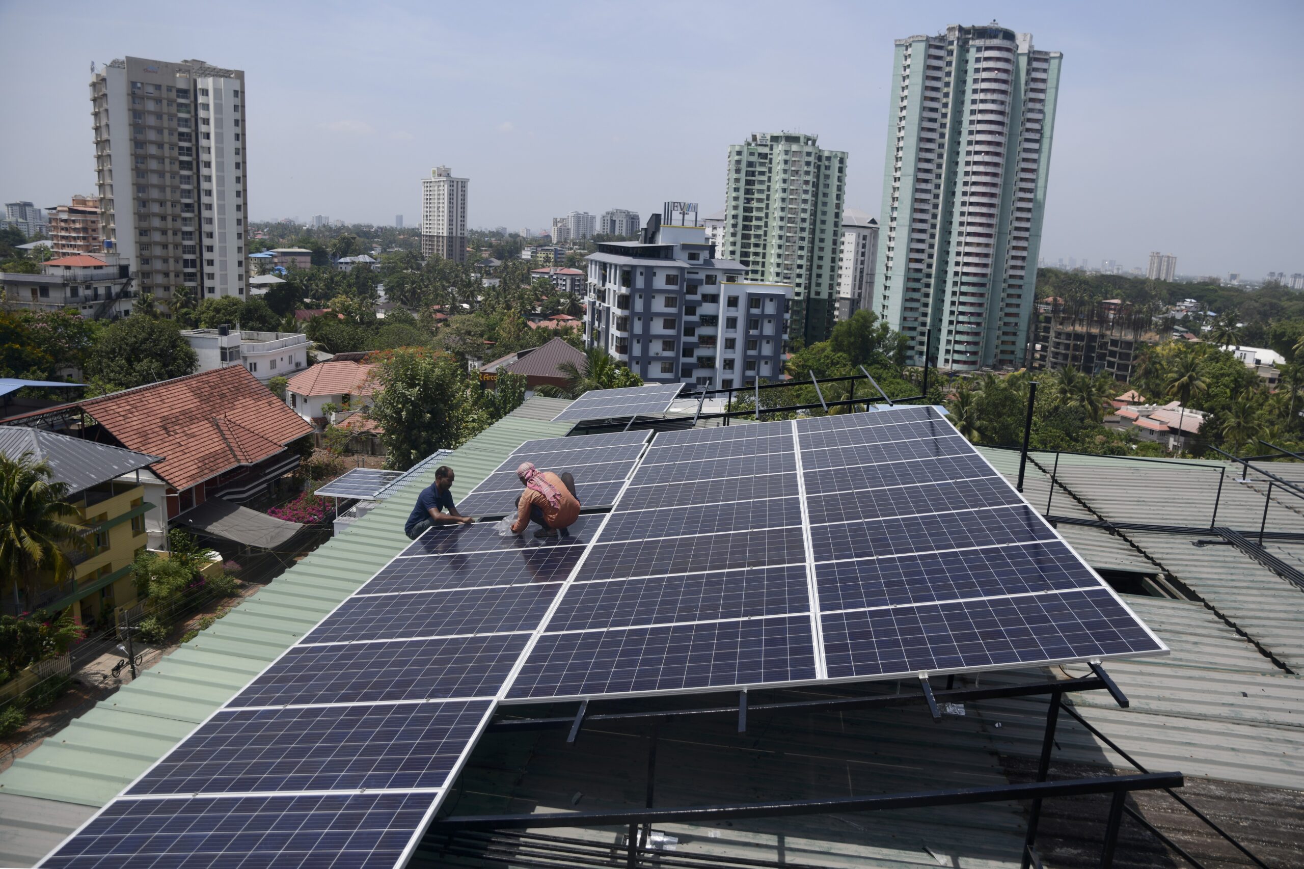 Workers installing solar panels in India - NDC-3 climate targets